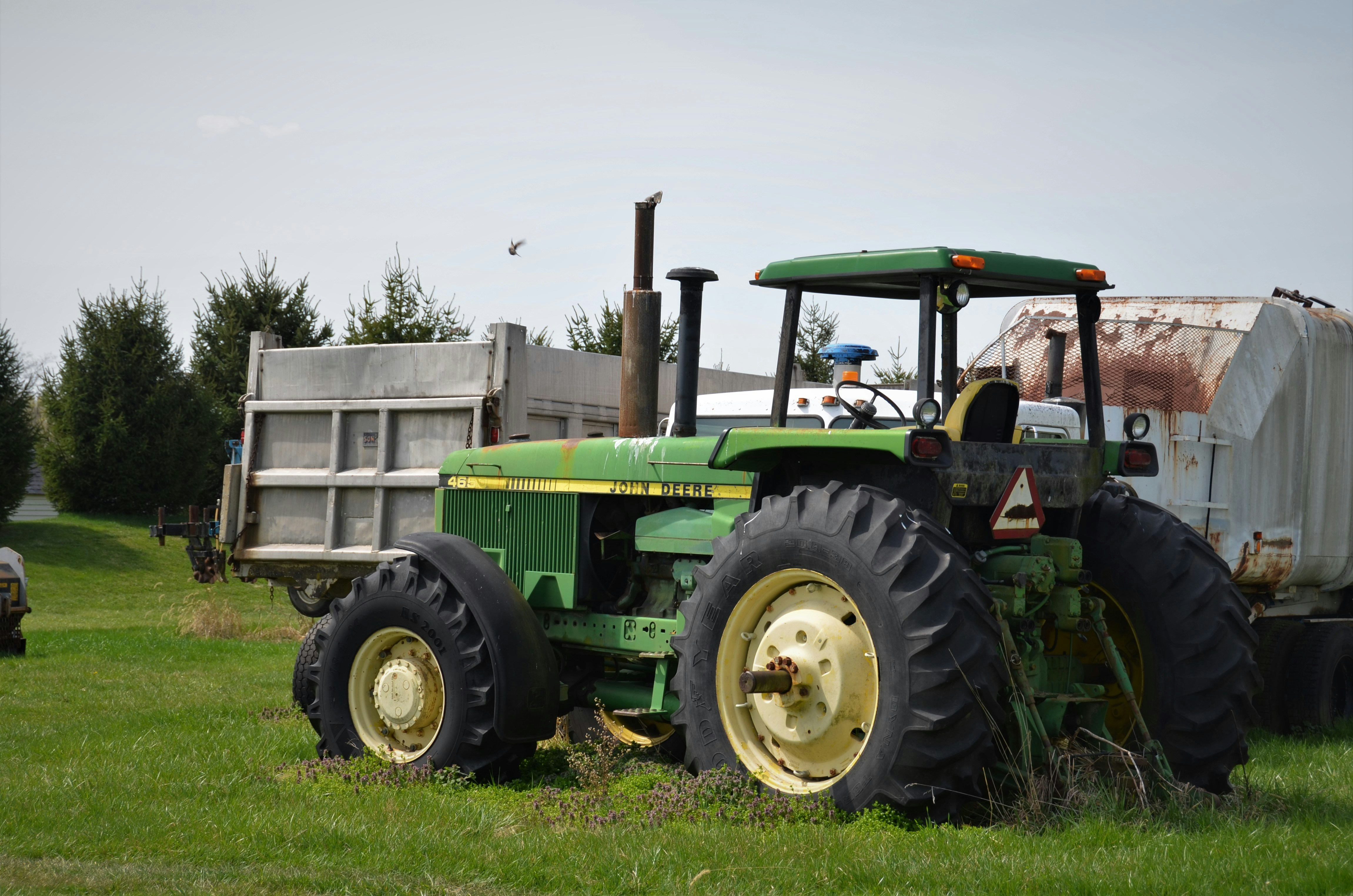 A tractor parked infront of a steel container